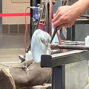 Pinching the bottom with the tool and water to prepare for a clean break from the rod.