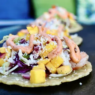 two tacos on a black plate