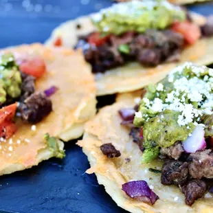 three tacos with various toppings