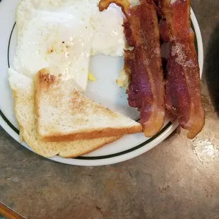 Awesome, perfectly cooked eggs, thick cut bacon,  and real buttered toast!