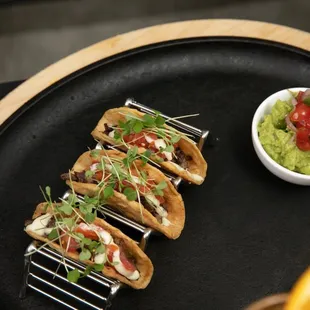 a plate of tacos and guacamole