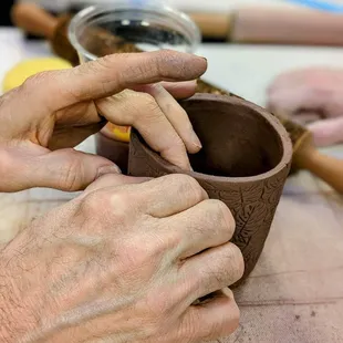 Hand-building a mug class with red clay