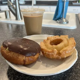 Boston creme doughnut and old fashioned doughnut with iced coffee.