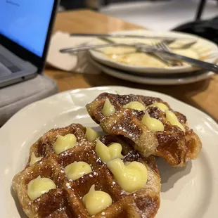 two waffles on a plate with butter