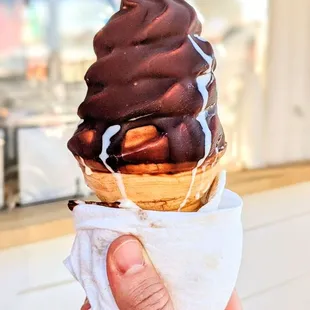 a hand holding a cone