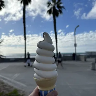 a person holding an ice cream cone