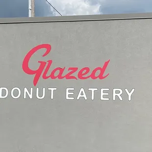 a sign for a donut eatery