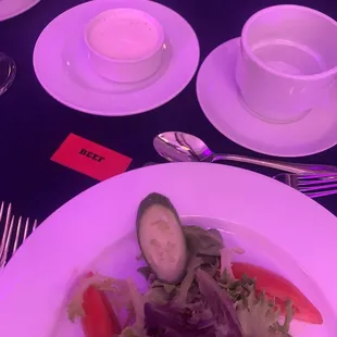a plate of salad with cucumbers and tomatoes