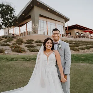 An absolutely stunning bride &amp; groom position in front of our grand Ivy Ballroom!! Book your dream Wedding with Glen Ivy!