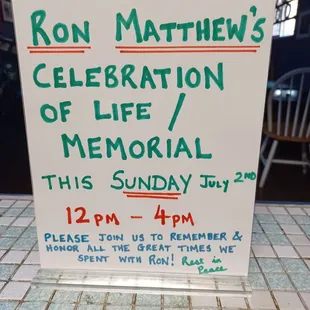a sign for ron matthews&apos;s celebration of life / memorial