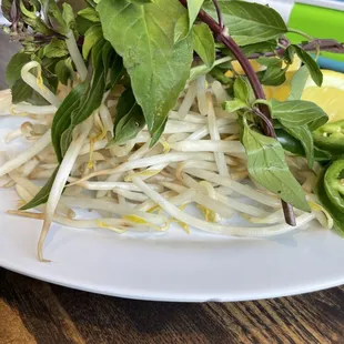 a plate of sprouts and a lemon