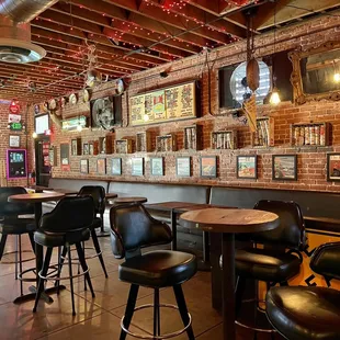 a bar with a pool table and stools