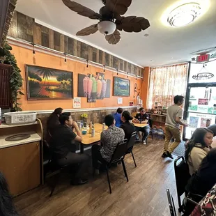 people sitting at tables in a restaurant