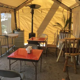 tables and chairs in a tent