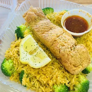 Fried salmon over rice with broccoli