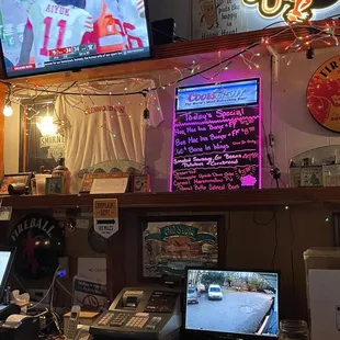 a bar with a television and a laptop