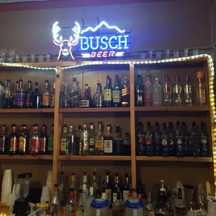 a shelf full of liquor bottles