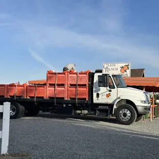 a white truck with orange crates
