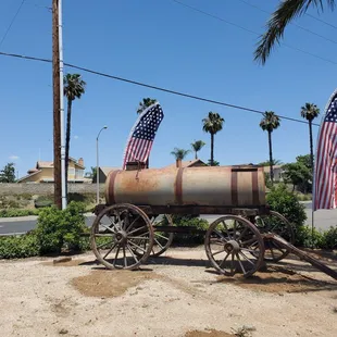 a rusted wagon with american flags on it