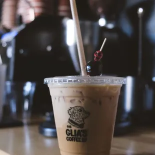 a cup of coffee with a cherry on top