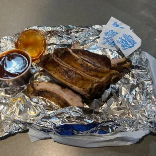 a plate of ribs and sauce
