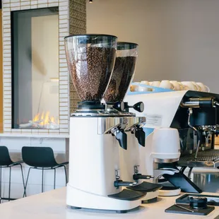 two coffee grinders on a counter