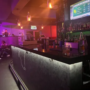 a bar with purple lighting