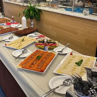 a variety of food on a buffet table