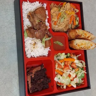 Our Bento Box special is consist of Chicken adobo bedded with steam rice, springrolls, house salad, pancit(noodles) and a dessert