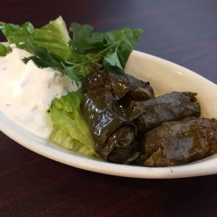 Stuffed grape leaves (Dolmas) Cucumber yogurt sauce.