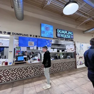 a man standing in front of a counter