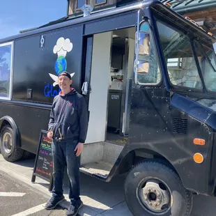 a man standing in front of a food truck