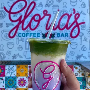 a hand holding a cup of coffee