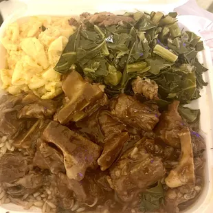 Oxtails dinner ( this is only a half an order )with Greens and macaroni and cheese
