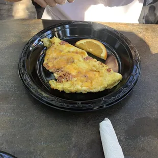 an omelet on a black plate