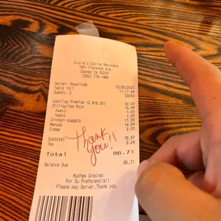 a hand holding a receipt