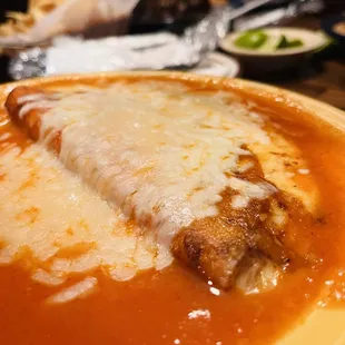 Cheese enchilada with red sauce