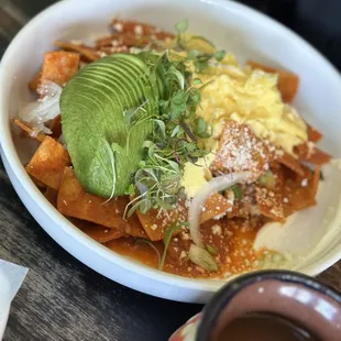 Red Chilaquiles   18.5 Corn tortillas, onion, sour cream, queso fresco, avocado &amp; 2 eggs.
