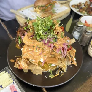 LOADED Barbacoa Nachos w/ guac, sour cream, jalapeños , beans, pickled onions, + more....... coming soon to menu