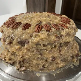 a cake with pecans on top