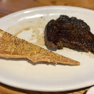 a piece of steak and a piece of bread