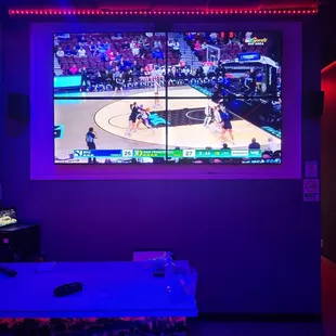 a basketball game on a big screen