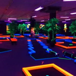 Trippy indoor mini golf where everything glows.