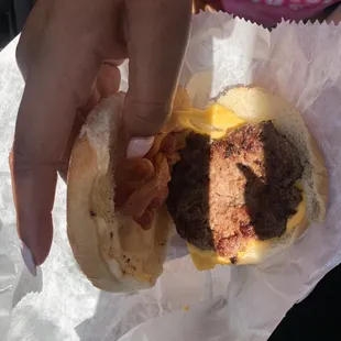 a hamburger with bacon and cheese