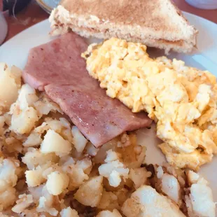 Eggs ham potatoes toast.
