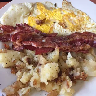 Fried eggs homefries and bacon.
