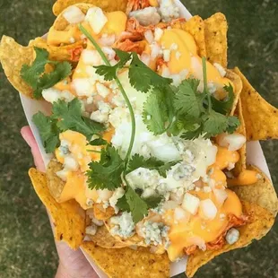 The Buffalo- cool ranch Doritos, corn tortilla chips, Franks Red buffalo chicken, sour cream, blue cheese, onion, and cilantro