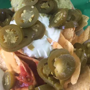 The classic. Corn tortilla chips, chunky red salsa, sour cream, jalapeños, guacamole, and cheddar cheese nacho sauce.