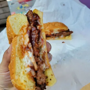 a hand holding a sandwich