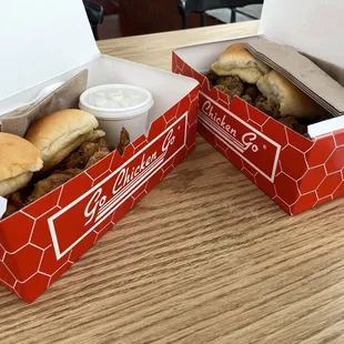 ows two takeout boxes on a table